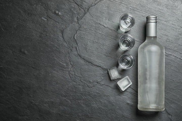 Cold Russian vodka on black table, flat lay. Space for text