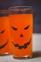 glasses with spooky pumpkins and cookies for Halloween