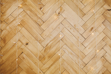 parquet wall texture. Christmas background with lights