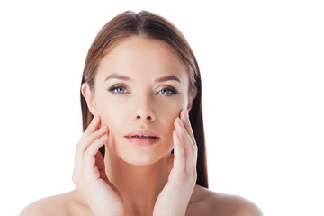 Massage your face. Use face cream and serum. Portrait of young beautiful woman isolated on white.