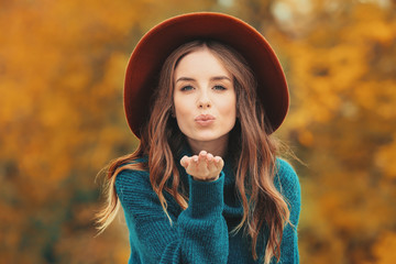 Portrait of stylish young woman in autumn park