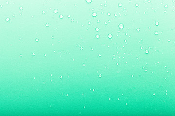 Drops of water on a color background. Selective focus. Green. Toned