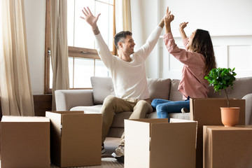 Excited husband and wife renters tenants celebrate moving day