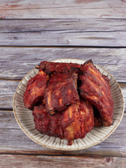 Homemade oven baked spareribs on rustic wooden background   
