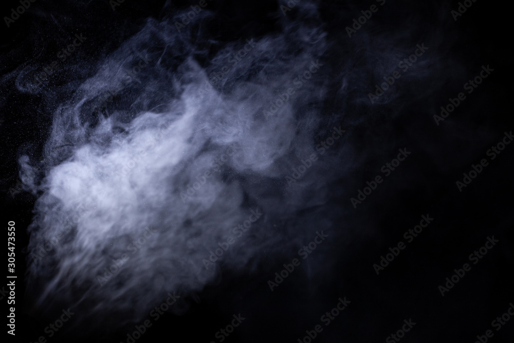 Wall mural jet of smoke on black background. selective focus