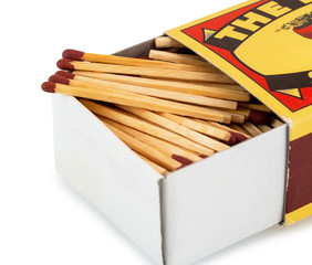 Vintage cardboard matchbox with matches isolated on white background with clipping path. Matches in open match-box on white underlay - retro style.