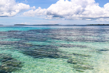 Clean and blue ocean and white beach in Papua New Guinea
