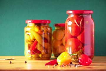 Preserved and fermented food in glass jars. Fermented food. Autumn canning. Сucumber, squash and tomatoes pickling and canning into glass jars.