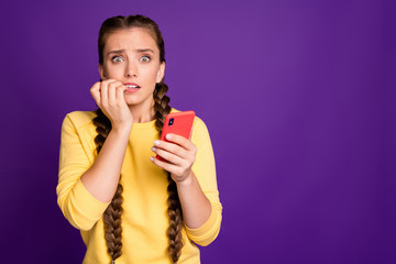 Oh no. Photo of millennial lady holding telephone reading fake news comments eyes full of fear...