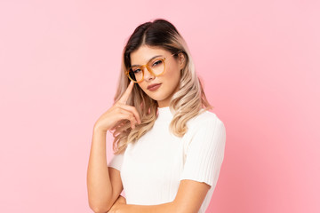 Teenager girl over isolated pink background with glasses