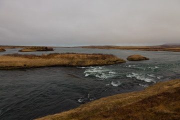 River and stunted grass on a dramatic landscape of Iceland
