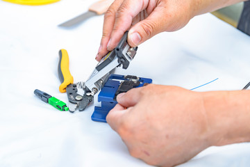 Expert technician Using a fiber-optic cable cutter With cutter For accuracy in work