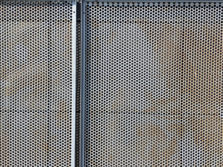 Old steel grating Filled with round shaped holes.