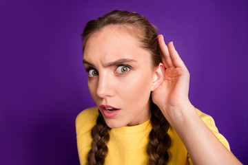 Closeup photo of funny lady long braids holding arm near ear listening fresh rumours chatterbox person wear casual yellow jumper isolated purple color background