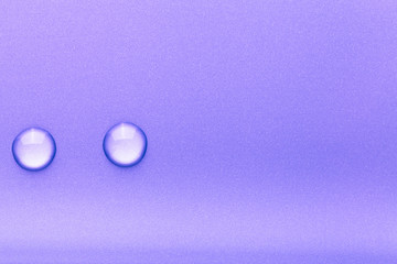 Drops of water on a color background. Violet. Toned
