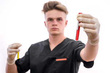 Chemistry and laboratory experiment concept. Man in medical uniform and protective gloves holding red test tube