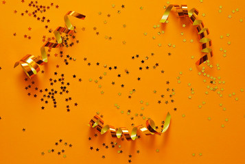 Ribbons and glitters on colorful background.