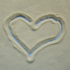 The heart is painted on a sandy surface. Concept, falling in love, Declaration of love.