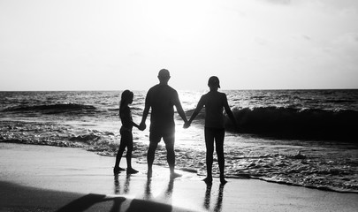 Father with two kids enjoying summer vacation on the beach