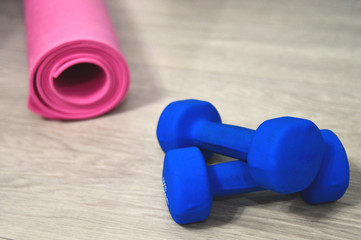 Healthy lifestyle. Dumbbells, Yoga mat, green apple and measuring tape. Sport. Lifestyle.