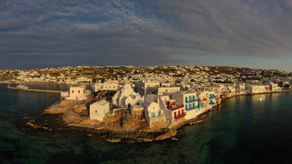 Aerial drone panoramic photo of picturesque old port in main village of Mykonos island at sunset...