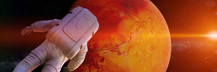 astronaut watching the sunrise during a space walk in orbit of planet Mars (3d science render banner) © dottedyeti