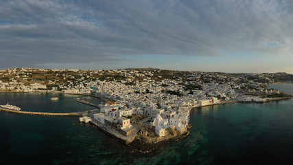 Obraz premium Aerial drone panoramic photo of picturesque old port in main village of Mykonos island at sunrise with beautiful colours, Cyclades, Greece