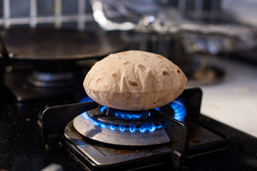 Cooking roti on a gas stove
