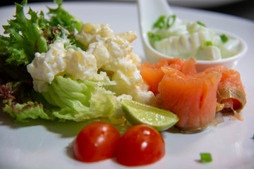  smoke salmon salad and sauce on plate