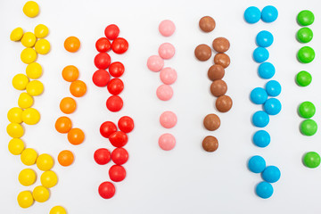 Multi-colored small jelly beans candies collected in line colors