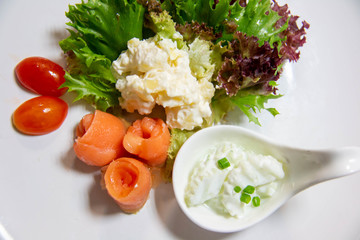  smoke salmon salad and sauce on plate
