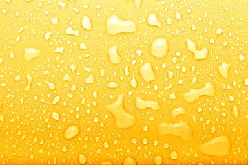Drops of water on a color background. Selective focus. Yellow. Toned