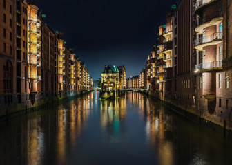 long exposure shot of canal in old warehouse district Speicherstadt in Hamburg, Germany at night