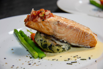  salmon steak with sauce on plate