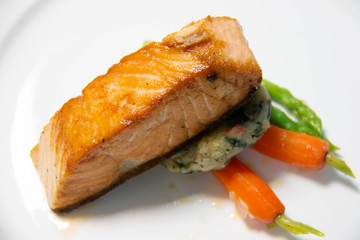  salmon steak with sauce on plate