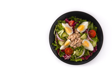 Salad with tuna, egg and vegetables isolated on white background. Top view. Copy space