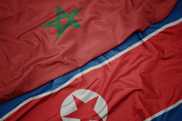 waving colorful flag of north korea and national flag of morocco.