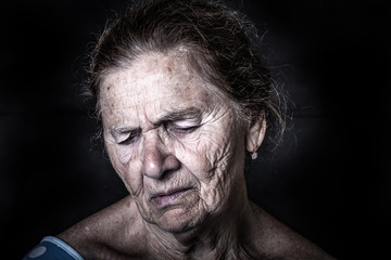 Portrait of an elderly woman with bright emotions on his face. Toned