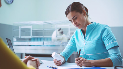 Professional vet writing a prescription