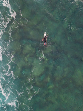 Aerial view of a man surfing at an agitated sea near Lo?inj coastline, Croatia.