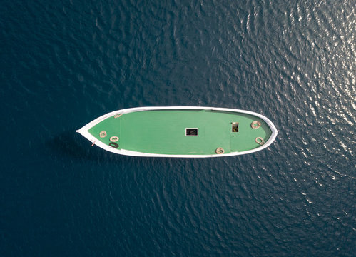 Aerial view above of unfinished boat anchored alone at Adriatic sea, Croatia.
