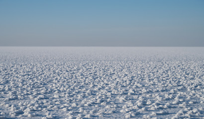 Frozen water surface. Ice to the horizon.