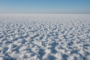 Frozen water surface. Ice to the horizon.