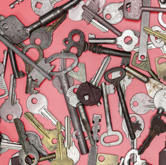 Keys set on pink background. Door lock keys and safes for proper
