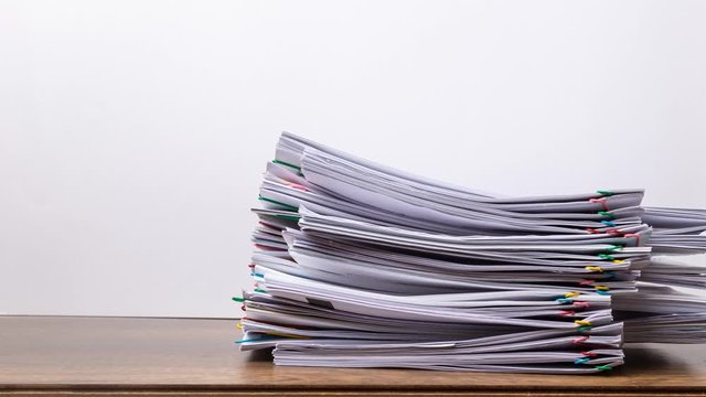 Stack overload document report paper with colorful paperclip on white background, business concept footage paperless used &ndash; 4K Stop motion.