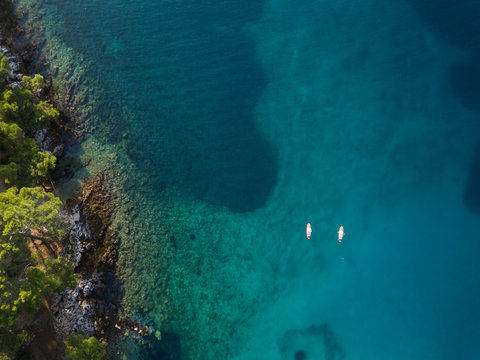 Aerial view of two persons practicing stand up paddle near Mali Lo?inj, Croatia.