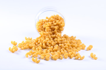  Glass jar filled with dry rotini yellow pasta over isolated white background
