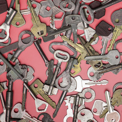 Keys set on pink background. Door lock keys and safes for proper