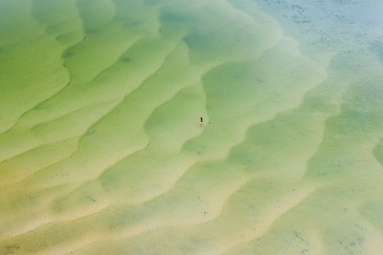 Aerial view of woman walking at the middle of Wallaga lake reserve, Australia.
