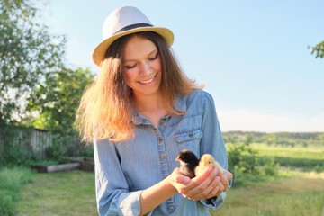 Country rustic style, Beautiful smiling teen girl with newborn baby chickens